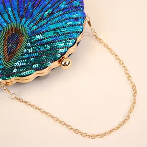 Detailed view of handmade sequin peacock evening clutch bag with exquisite bead embroidery.