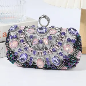 Luxury rhinestone evening clutch bag with purple pink crystals and metal ring handle for party.