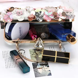 Elegant floral evening bag with beaded 3D flowers, metallic frame clasp, perfect for banquets.