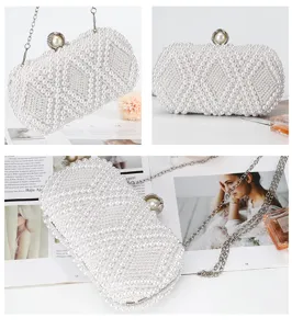 Handmade white pearl evening clutch bag detail, elegant bridal shoulder bag with chain.