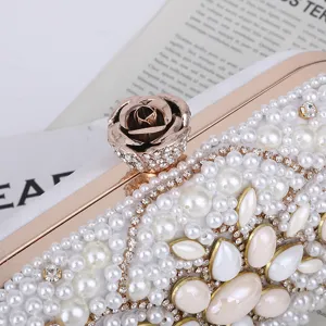 Elegant pearl embellished evening clutch bag with rhinestone and rose clasp for women.
