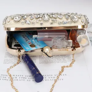 Vintage rhinestone evening clutch bag with beaded details, pearl clasp, and metal chain strap.
