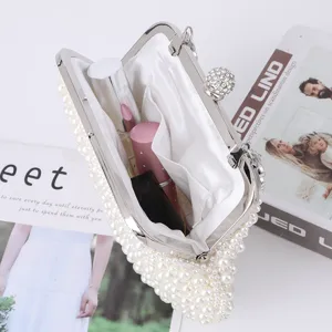 Elegant pearl shell evening bag with sparkling rhinestone clasp, perfect for parties and weddings.