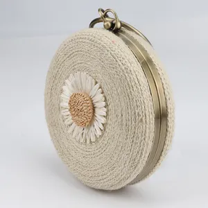 Round straw woven bag with cute daisy motif, vintage metal kiss-lock clasp beach handbag.