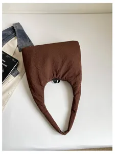 Brown crinkled hobo shoulder bag detail shot, casual stylish large capacity commuter handbag.