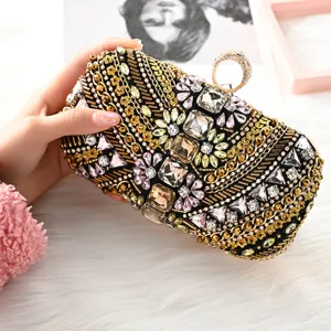 Luxury rhinestone crystal evening clutch bag with ring handle and beaded embroidery design.