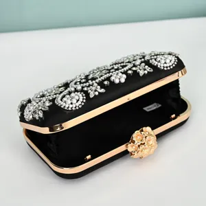 Elegant black satin clutch purse with sparkling pearls and crystals for evening party.