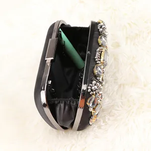 Black satin rhinestone evening clutch bag with metal frame and sparkling crystal bead details.