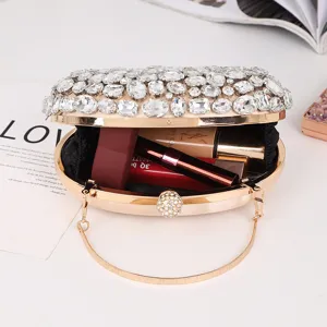 Detail view of luxury champagne crystal oval evening clutch bag with sparkling rhinestones.