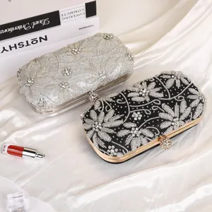 Exquisite handmade rhinestone embroidered evening clutch bag detail view, luxury beaded design.