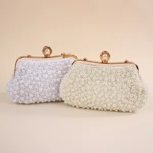 Stunning elegant pearl evening clutch bag with gold-tone hardware for weddings and events.