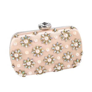 Elegant champagne satin evening clutch bag with sparkling rhinestone floral and pearl decor.