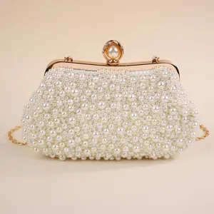 Elegant pearl evening clutch bag with gold chain and clasp, perfect for formal dresses and parties.
