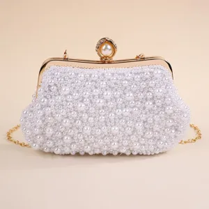 Exquisite detail view of the handmade pearl evening clutch with luxury gold clasp and chain.