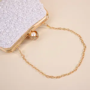 Pearl evening clutch bag with gold chain, elegant white beaded bridal purse detail.