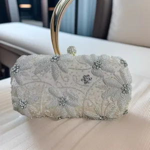 Handmade beaded rhinestone evening clutch bag with elegant floral embroidery and metal handle.