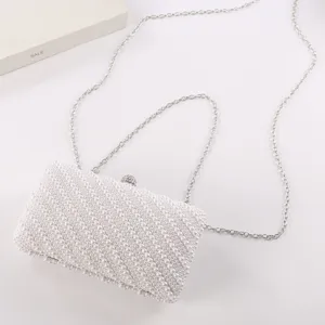 Elegant white pearl clutch bag with silver chain strap, perfect for evening parties.