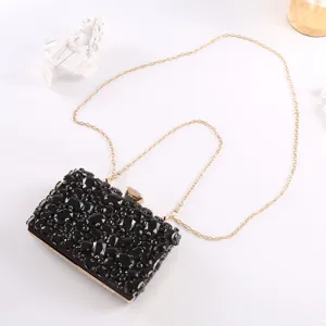 Elegant black crystal evening clutch bag with gold chain strap for women parties.