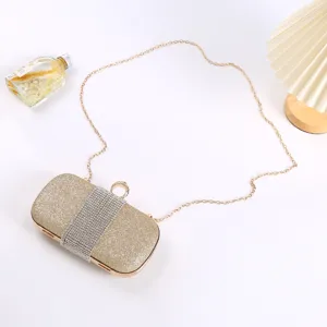 Gold glitter evening clutch bag with rhinestone band and chain strap for women party.