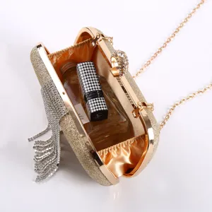 Gold glitter evening clutch bag with rhinestone ring clasp, crystal tassel and chain strap.