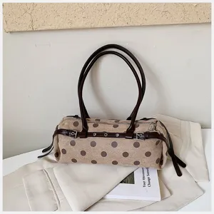 Chic polka dot shoulder bag, vintage underarm baguette design with brown straps and stylish details.