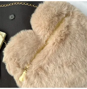 Fluffy heart-shaped crossbody bag detail, cute faux fur shoulder bag with gold chain.