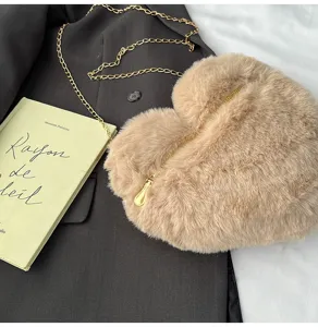 Chic heart-shaped plush crossbody bag for women, soft furry shoulder bag with gold chain.