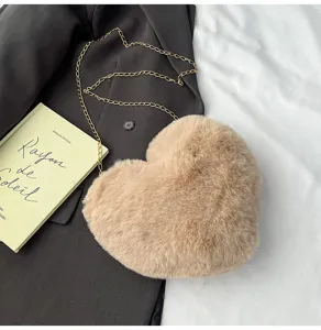 Close-up of the plush heart-shaped crossbody bag featuring soft fuzzy texture and gold chain.