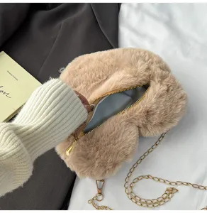 Detailed view of the cute plush heart-shaped crossbody bag with gold chain strap for women.