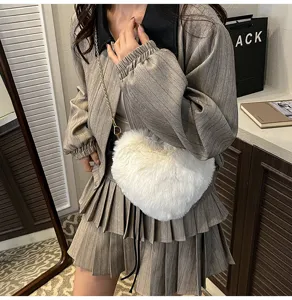 Fluffy heart-shaped crossbody bag for women, cute winter plush chain shoulder handbag daily use.