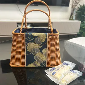 Hand-woven rattan trapezoid handbag with exquisite embroidered cloud pattern and soft lining.