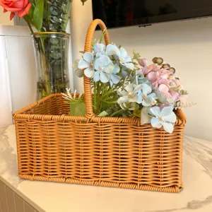 Imitation rattan storage basket with handle, decorative floral arrangement detail view.