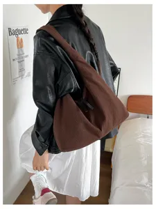 Detailed view of brown slouchy shoulder bag, large capacity hobo bag for women daily commute.