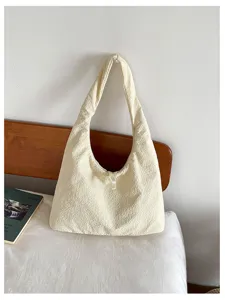 Detailed view of the off-white textured slouchy shoulder bag showcasing its soft fabric and design.