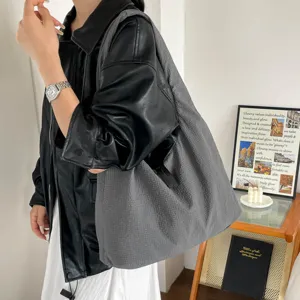 Large capacity casual shoulder bag for women, minimalist slouchy design for daily commute.