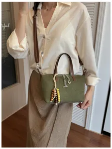 Grüne Wildleder Damen Umhängetasche Schultertasche mit braunem Lederriemen und Perlen.