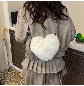 Plush heart crossbody bag for women, cute fluffy winter shoulder bag with chain strap.