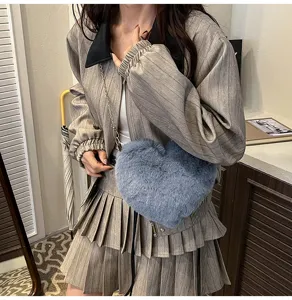 Trendy fluffy heart crossbody bag paired with stylish gray pleated jacket and skirt set.