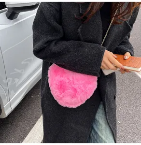 Pink plush heart crossbody bag for women, cute winter fuzzy chain shoulder handbag.