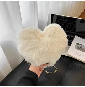 Detailed view of the cute fuzzy heart plush handbag with gold chain strap, soft texture.