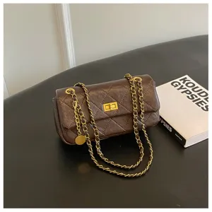 Brown quilted chain shoulder bag, classic flap design with metal twist lock and leather strap.