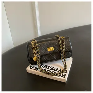 Black quilted leather shoulder bag with gold chain strap, classic design for women's daily commute.