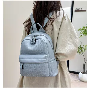 Detail view of the casual leather backpack, showing shoulder straps and textured finish.