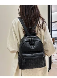Close-up view of the black quilted backpack showing detailed texture, strap and zipper design.