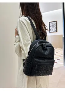 Black leather backpack detail view showing soft texture, metal zippers, and convenient daily design.