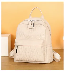 Casual beige faux leather backpack for women, stylish campus school bag with zip pockets.