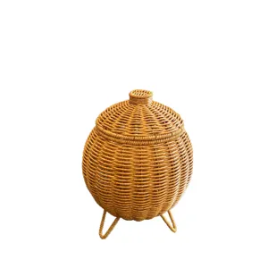 Handmade rattan woven lidded round storage basket with tripod stand for desktop sundries.