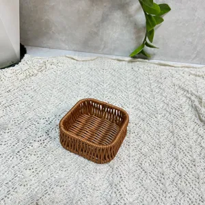 Close-up detail of the brown square imitation rattan woven storage basket on textured background.