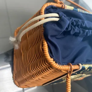 Woven basket detail view showing intricate rattan texture and blue fabric drawstring lining.