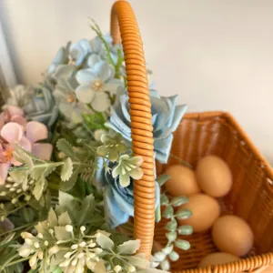 Wicker flower basket with artificial blue roses and eggs pastoral storage design detail